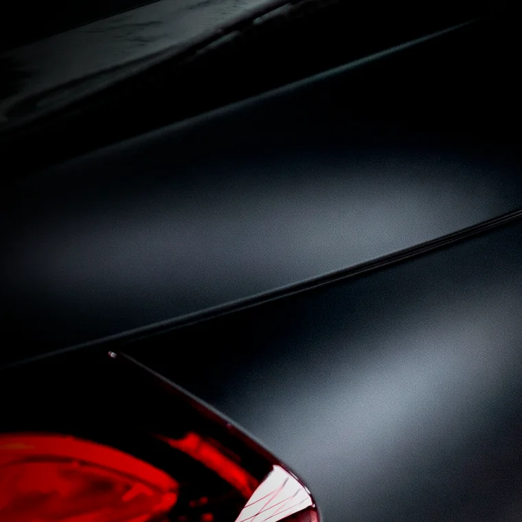 Superficie de pintura negra mate con un reflejo rojo
